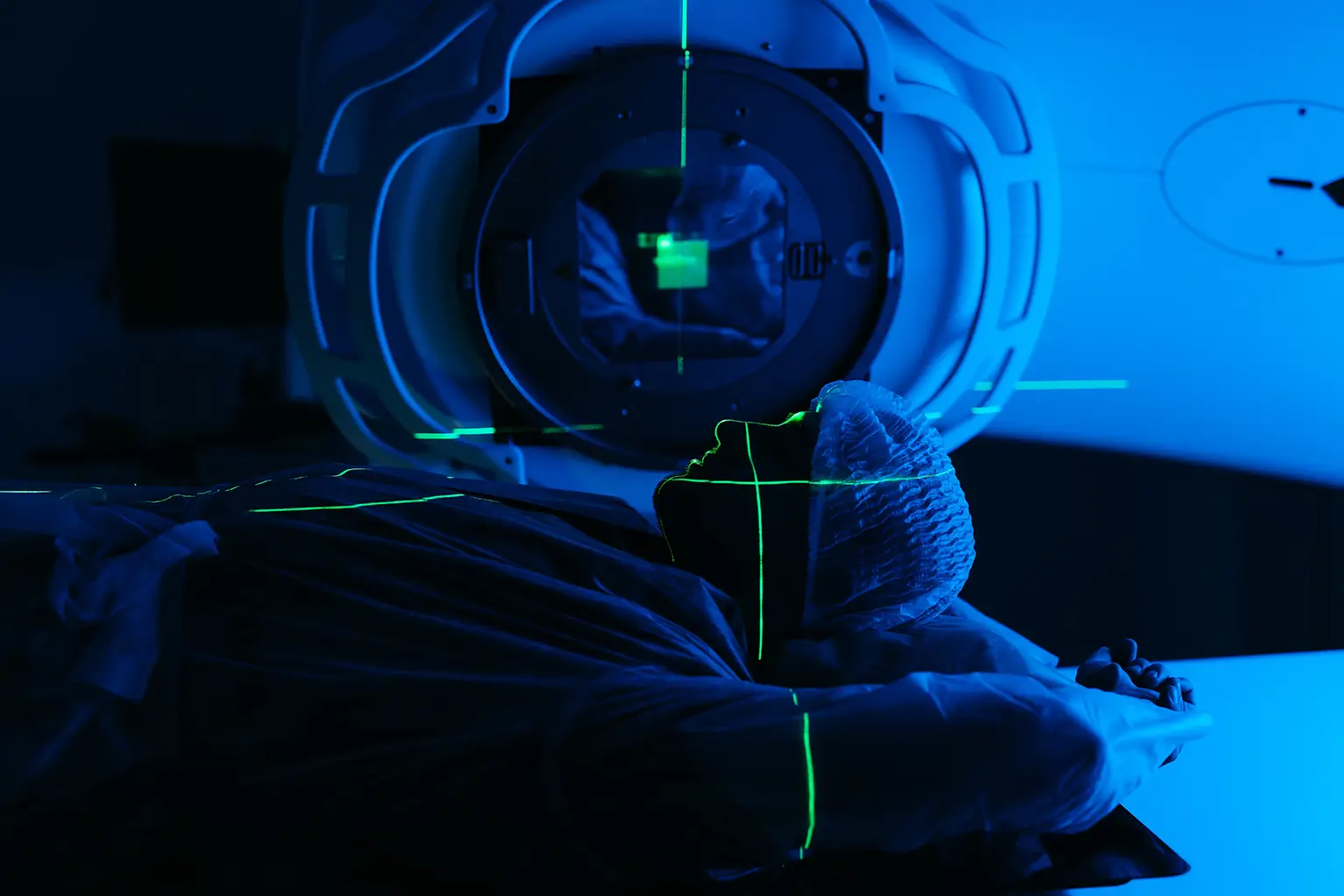 Patient Undergoing Cancer Radiation Therapy under a Machine with Green Laser Alignment Lines