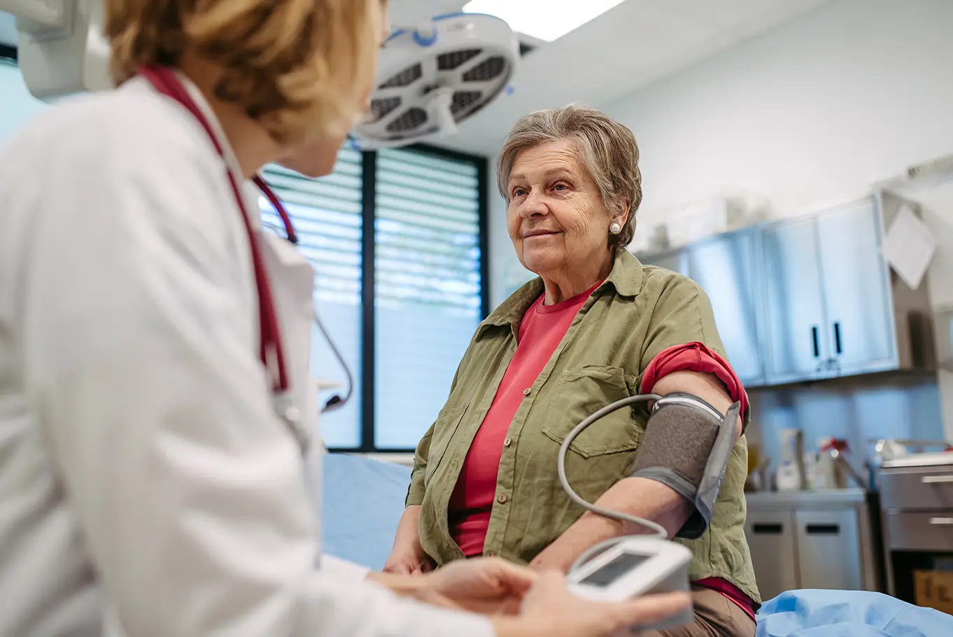 Taking a patient's blood pressure in a doctor office