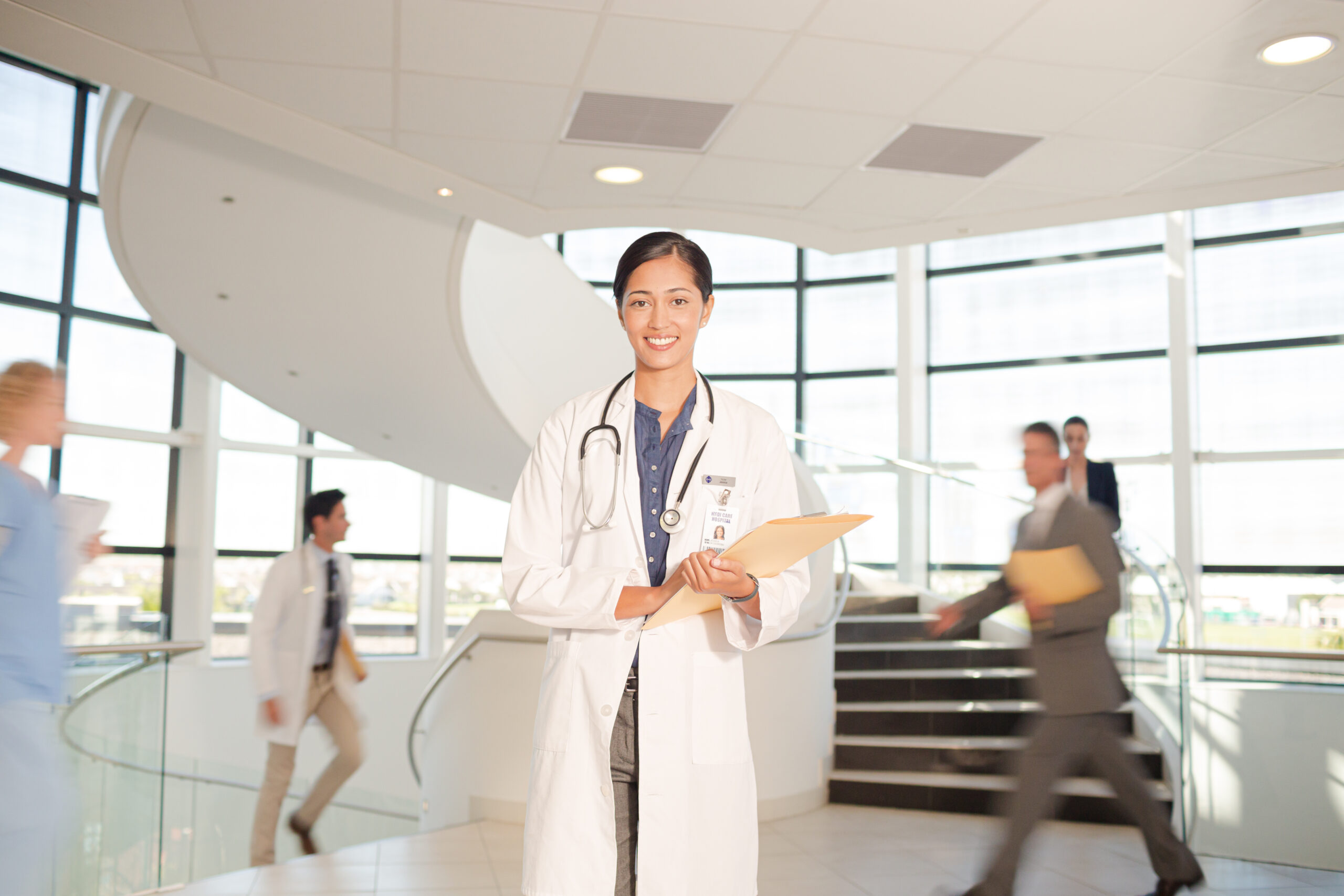 Portrait of smiling doctor in hospital atrium