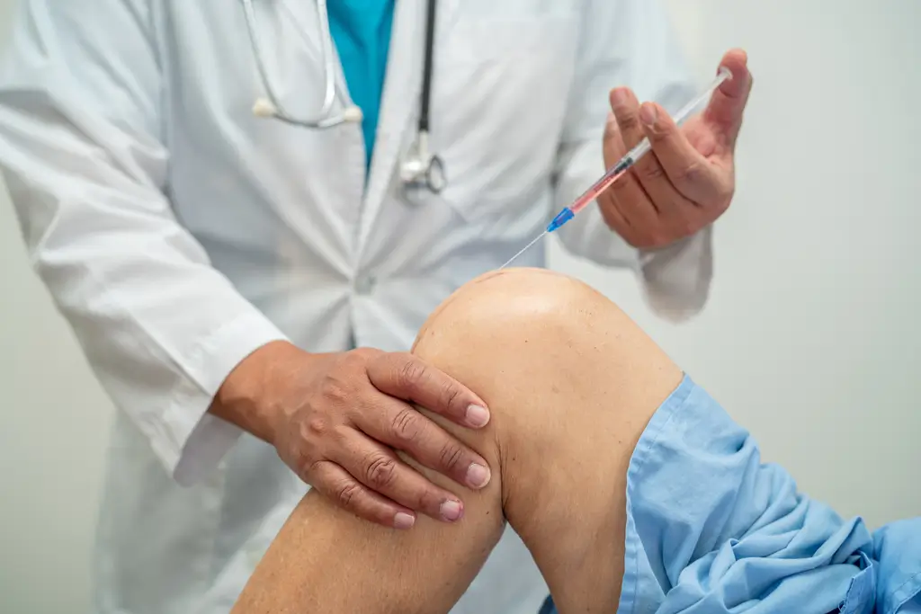 Great Falls -Pain Management Doctor administering an injection into a patient's knee joint